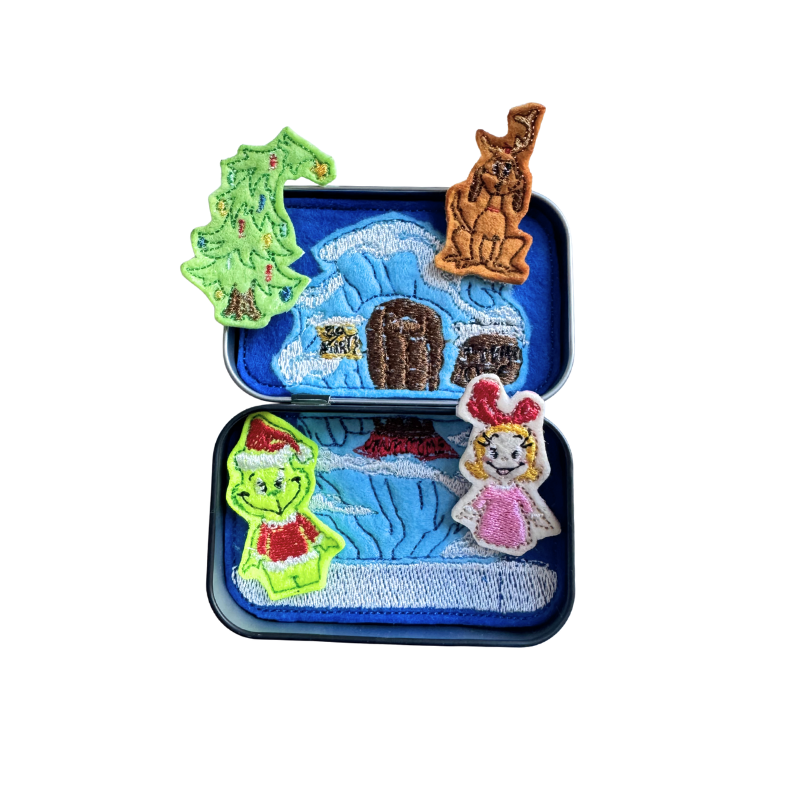 Set of Christmas-themed embroidered patches including a tree, house, cat, and characters on a white background.
