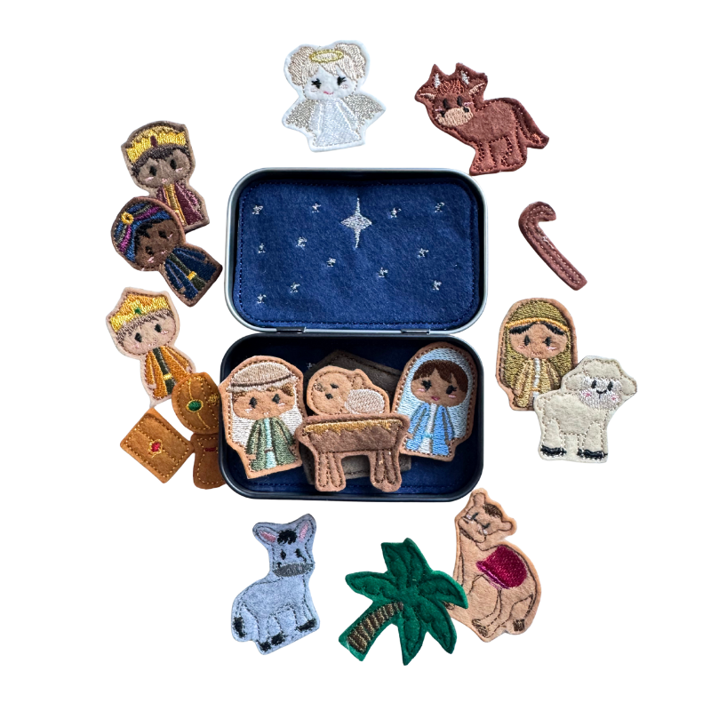 Set of embroidered nativity scene characters in a tin with a star on a white background
