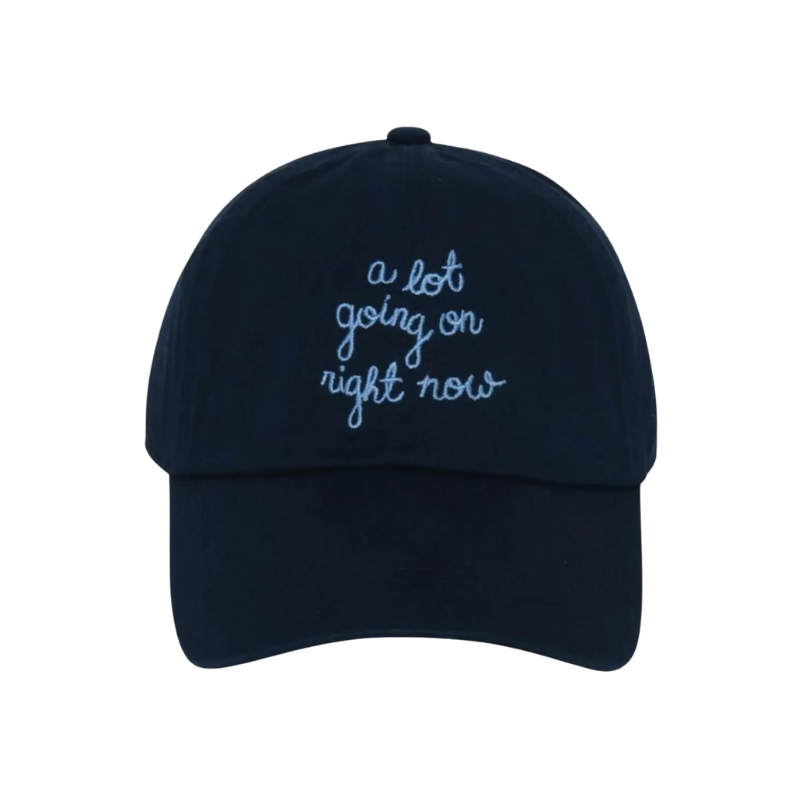 Navy blue cap with white text 'a lot going on right now' on a white background