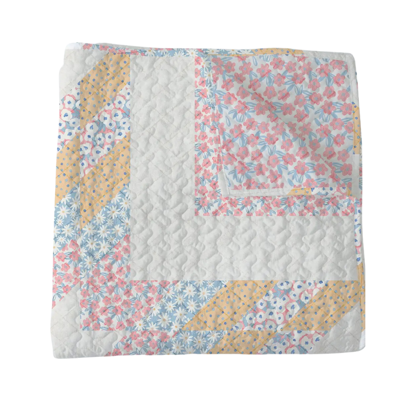 Floral quilt with a patchwork design on a white background