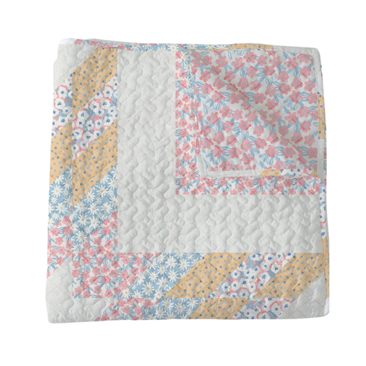 Floral quilt with a patchwork design on a white background