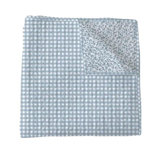 Baby blanket with blue checkered pattern on a white background