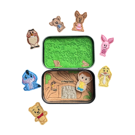Set of embroidered characters around a small tin with embroidered design