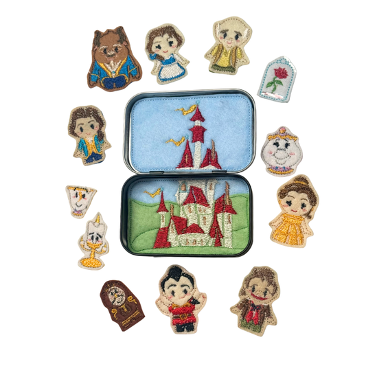Set of decorative pins featuring characters from a fairy tale, displayed around a tin with a castle design.