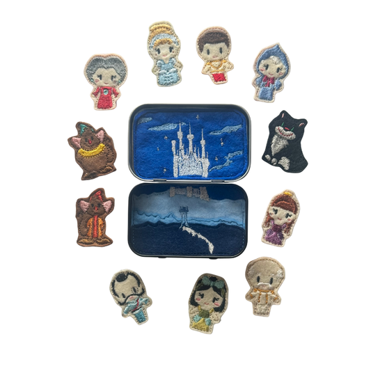 Collection of small character figurines around a decorative tin with a castle design on a white background.
