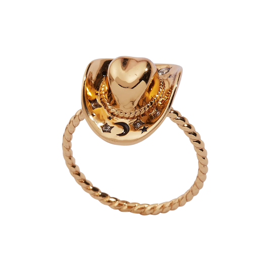 Gold ring with heart-shaped top and star and moon designs on a white background