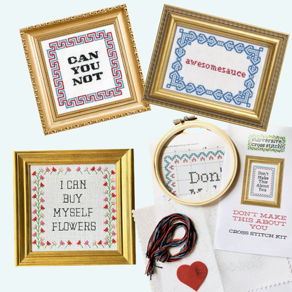 Cross stitch kits with framed text and embroidery hoop on a white background