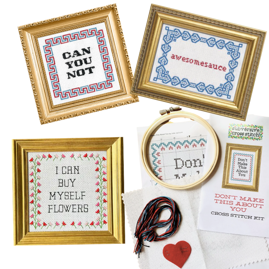 Cross stitch kits with framed designs and embroidery hoop on a white background