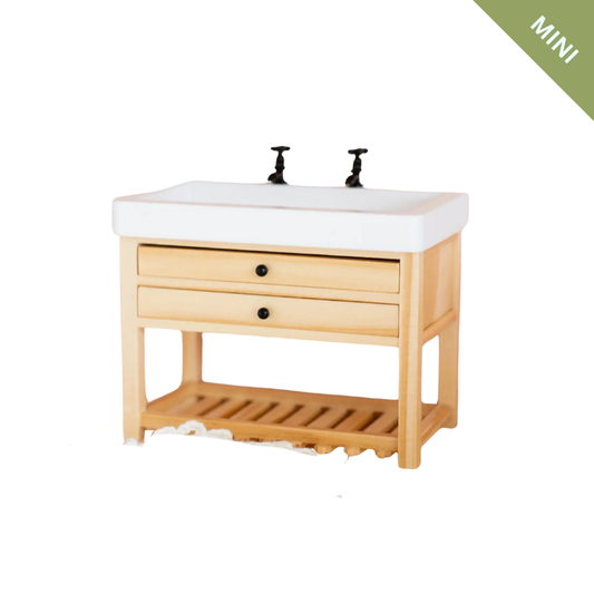 Wooden vanity with white sink and two black faucets on a white background