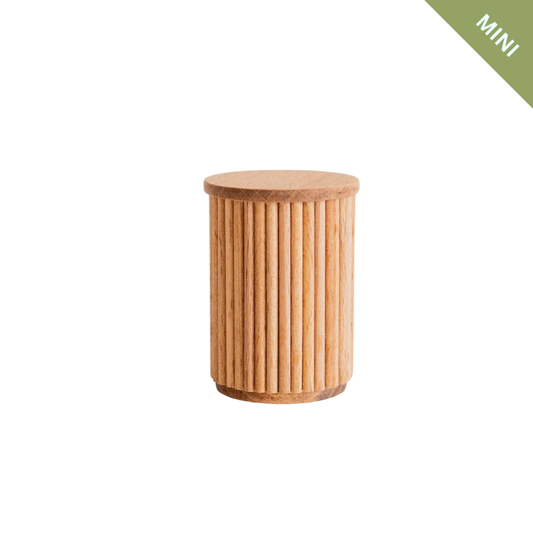 Wooden cylindrical stool on a white background with 'MINI' label in green corner.