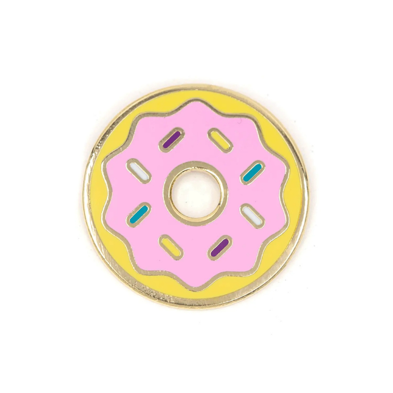 Donut-shaped enamel pin with pink center and yellow rim on a white background