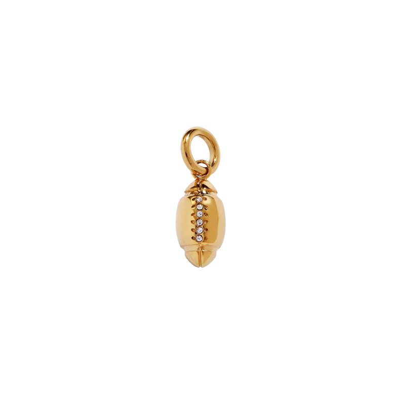 Gold football-shaped charm with embedded stones on a white background