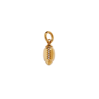 Gold football-shaped charm with embedded stones on a white background
