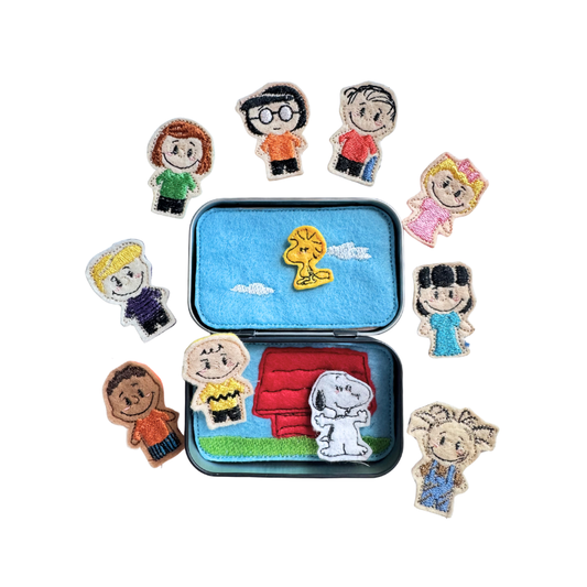 Set of embroidered characters around a small open suitcase with embroidered images on a white background