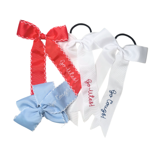 Set of three hair bows with ribbons and text on a white background