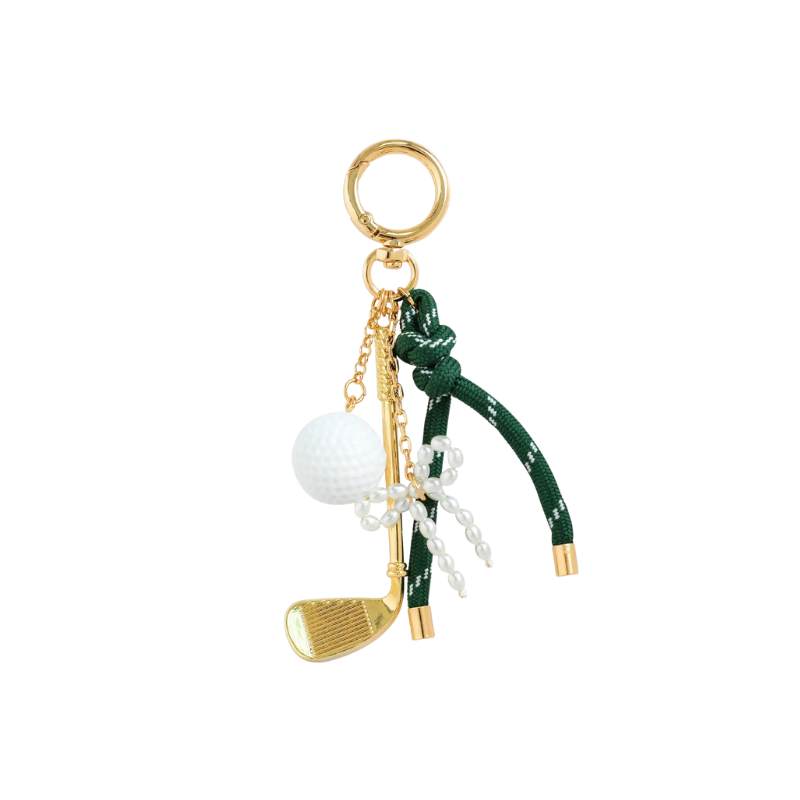 Golf club and ball keychain on a white background