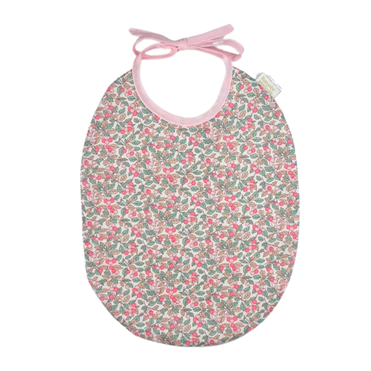 Floral-patterned baby bib with pink straps on a white background