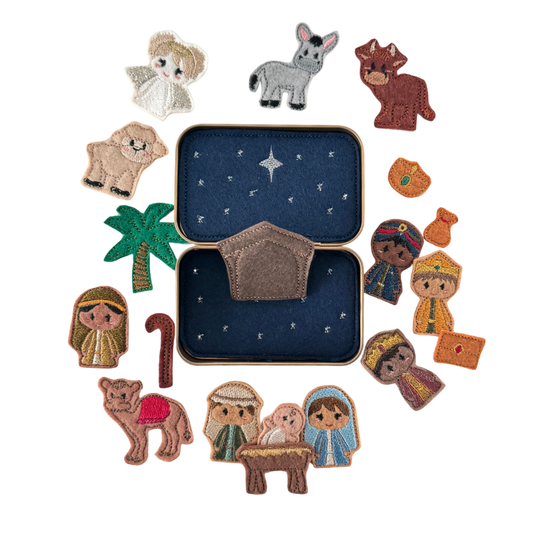 Set of embroidered nativity scene characters on a white background