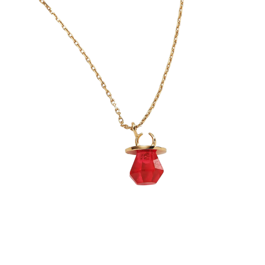 Gold necklace with a red pendant on a white background