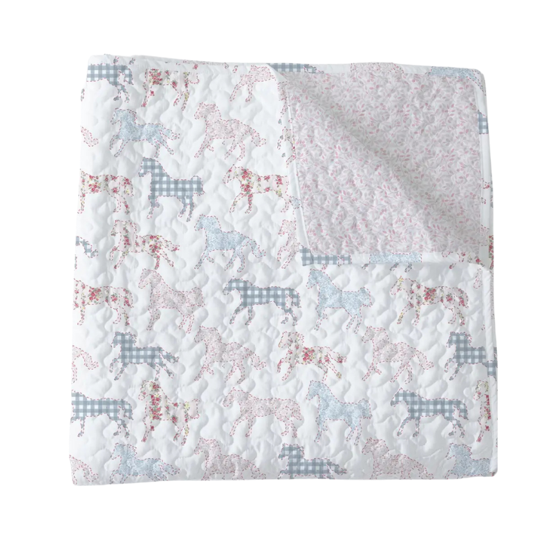 Quilt with horse pattern on a white background