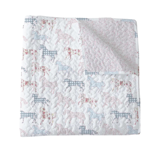 Quilt with horse pattern on a white background
