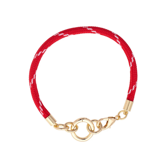 Red bracelet with gold clasp on a white background