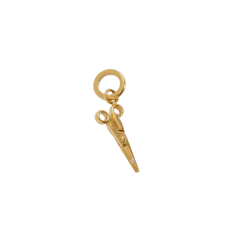 Gold scissors charm on a white background