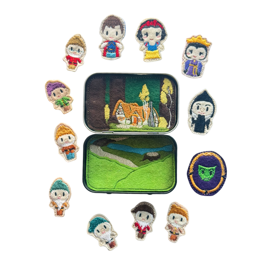 Collection of embroidered characters in a tin with a white background