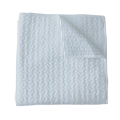 Textured quilt with a subtle pattern on a white background