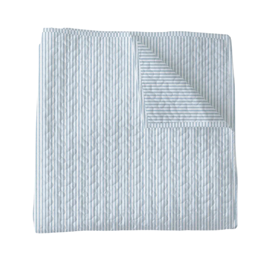 Textured quilt with a subtle pattern on a white background