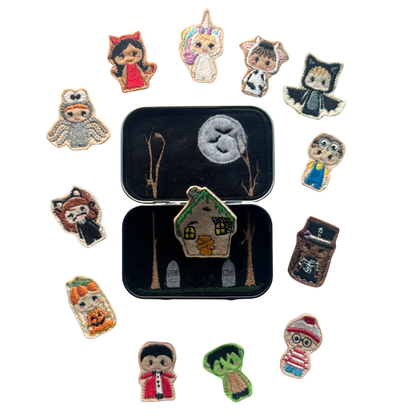 Collection of colorful embroidered patches featuring various characters and a house design on a white background.